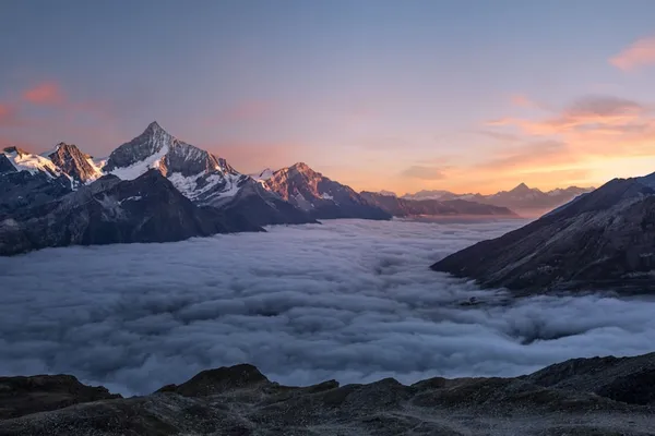 Snow-capped mountain peaks at golden hour